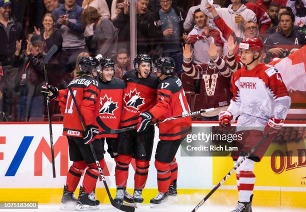 Morgan Frost of Canada celebrates with teammates Jaret Anderson-Dolan, Ty Smith and Nick Suzuki after scoring his third goal of the game as Lasse...