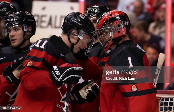 Jaret Anderson-Dolan congratulates goalie Michael Dipietro of Canada after defeating Denmark 14-0 in Group A hockey action of the 2019 IIHF World...