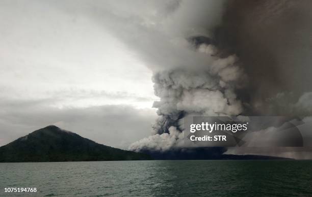 This picture taken on December 26, 2018 shows the Anak Krakatoa volcano erupting, as seen from a ship on the Sunda Straits. Indonesia on December 27...