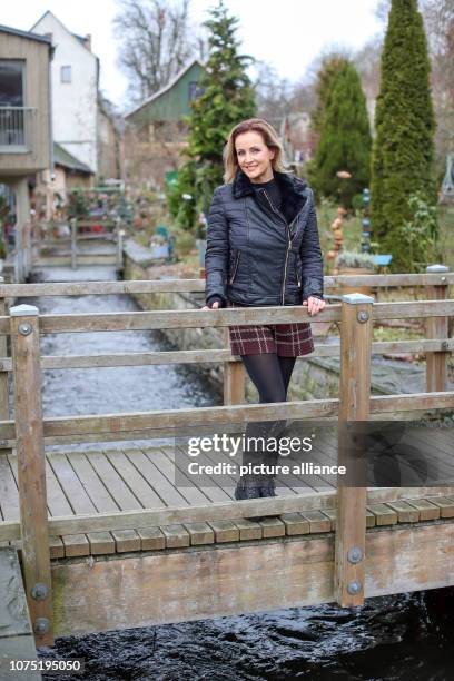 December 2018, Saxony, Plauen: Evelyn Reißmann, freshly elected Miss 50plus Germany, stands on a bridge over the Mühlgraben at the Weberhäuser in...