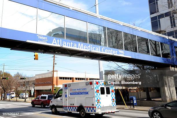 An ambulance drives under an overpass outside of Tenet Healthcare's Atlanta Medical Center in Atlanta, Georgia, U.S., on Friday, Dec. 10, 2010....