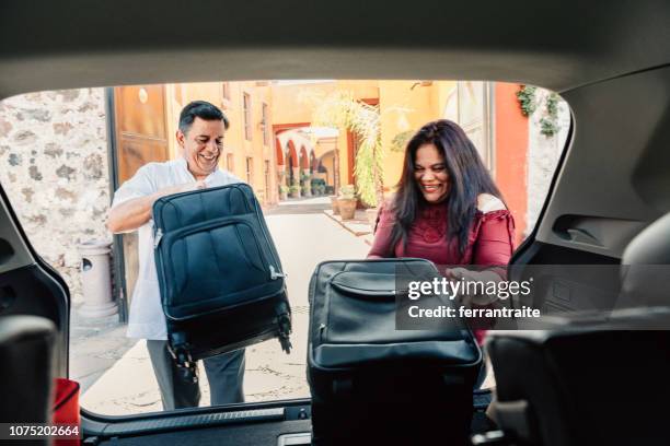 senior couple arrive at mexican hotel - old boots stock pictures, royalty-free photos & images