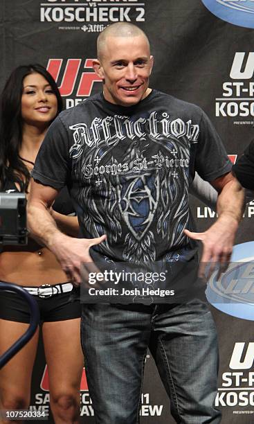 Welterweight Champion Georges St-Pierre plays up to the crowd after making weight at the UFC 124 Weigh-in at the Bell Centre on December 10, 2010 in...
