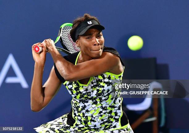 Venus Williams of the US plays the ball to Serena Williams of the US, during the 2018 Mubadala World Tennis Championship match in Abu Dhabi, on...