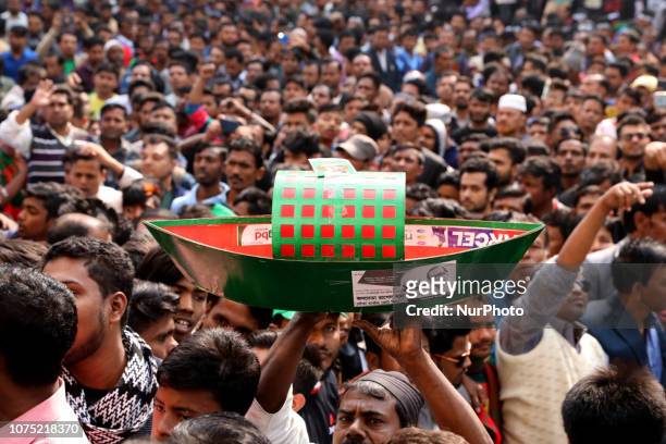 Supporters of Bangladesh Awami League march along a street as they take part in a rally ahead of December 30 general election vote, in Dhaka,...