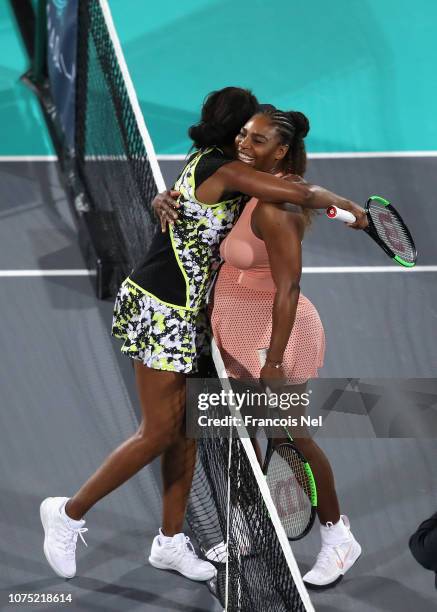 Serena Williams of United States congratulates Venus Williams after winning her women's singles match on day one of the Mubadala World Tennis...