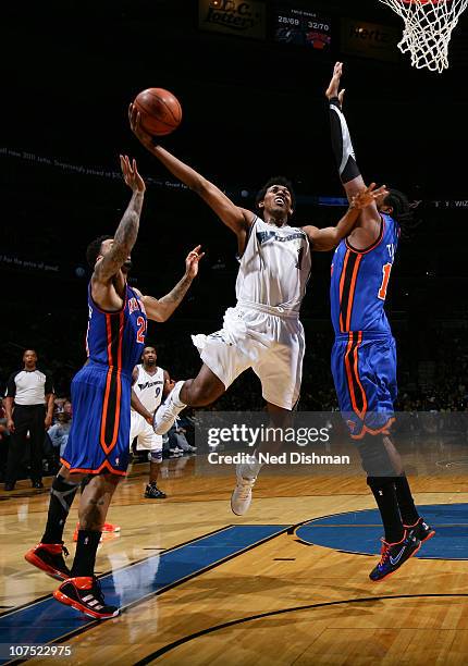 Nick Young of the Washington Wizards shoots against Wilson Chandler and Ronny Turiaf of the New York Knicks at the Verizon Center on December 10,...