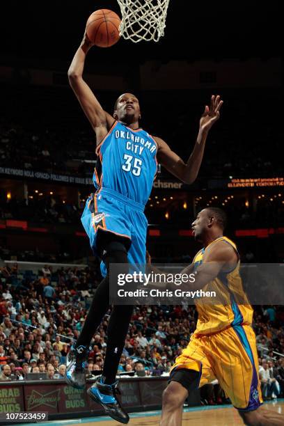 Kevin Durant of the Oklahoma City Thunder dunks the ball over D.J. Mbenga of the New Orleans Hornets at New Orleans Arena on December 10, 2010 in New...