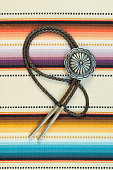 Vintage Silver Bolo Tie on colorful background.