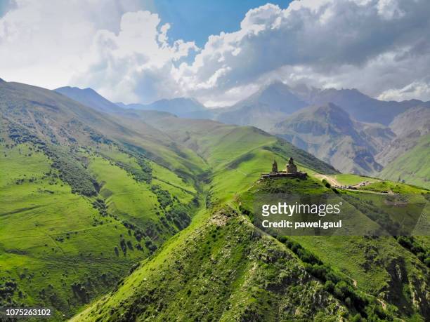 vue aérienne des montagnes du caucase avec l’église de la trinité de guérguéti - georgian photos et images de collection