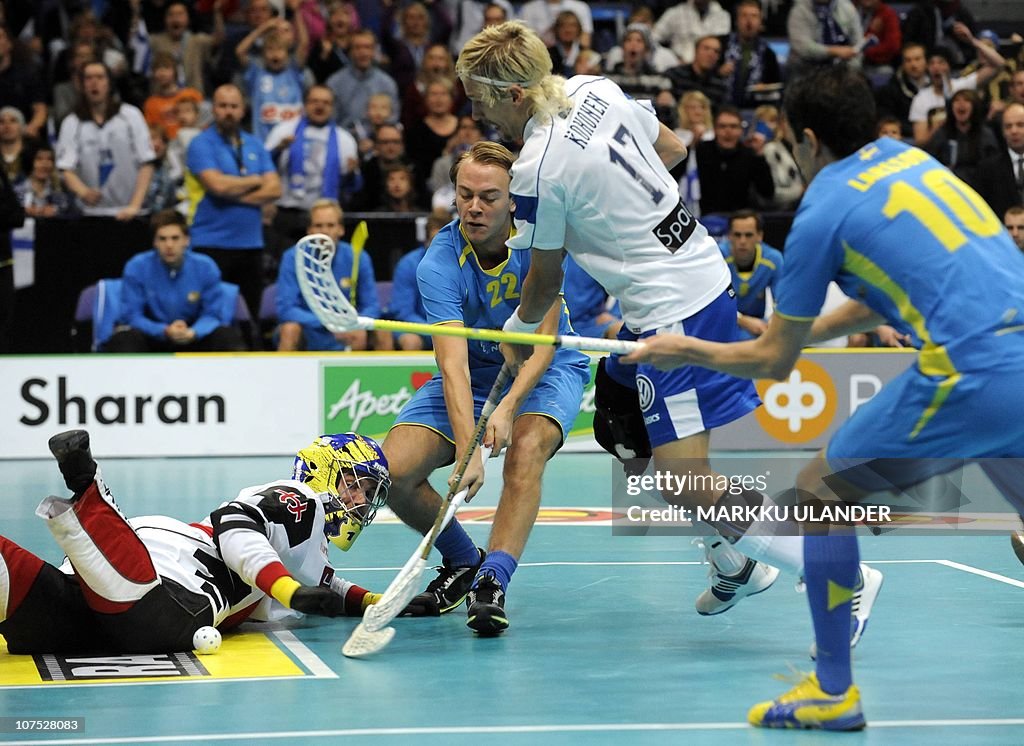 Mikko Kohonen (C) of team Finland tries