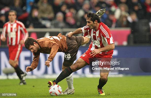 Hamit Altintop of FC Bayern Muenchen and Moritz Volz of FC St. Pauli challenge for the ball during the Bundesliga match between FC Bayern Muenchen...