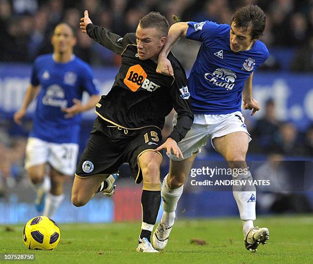 Everton's English defender Leighton Baines vies with Wigan Athletic's English midfielder Tom Cleverley during the English Premier League football...