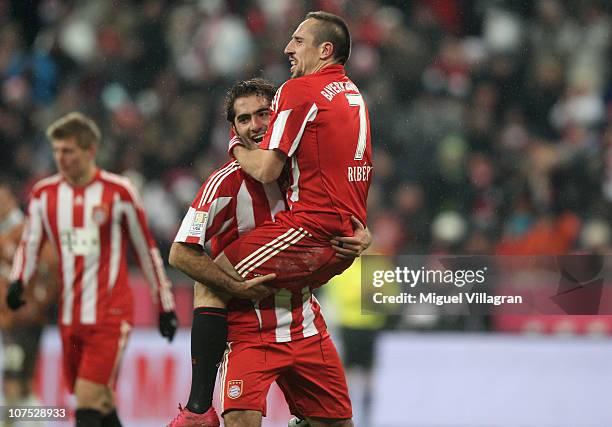 Franck Ribery of FC Bayern Muenchen celebrates his side's third goal with his team mate Hamit Altintop during the Bundesliga match between FC Bayern...