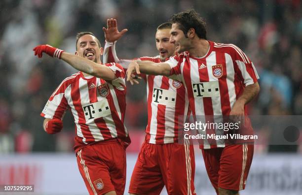 Franck Ribery of FC Bayern Muenchen celebrates his side's third goal with his team mates Diego Contento and Hamit Altintop during the Bundesliga...