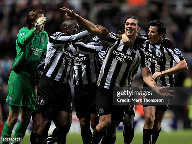 Andy Carroll of Newcastle United celebrates scoring his team's third goal with his team mates during the Barclays Premier League match between...