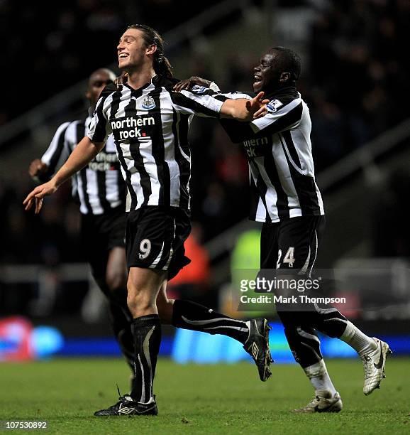 Andy Carroll of Newcastle United celebrates scoring his team's third goal with team mate Cheik Tiote during the Barclays Premier League match between...