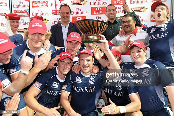 Scotland team-mates celebrate with the trophy after the Bowl final against Russia on day 2 of the HSBC Sevens World Series Emirates George Sevens at...