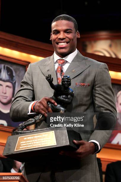 Quarterback Cam Newton of the Auburn University Tigers poses with the trophy after being named the 76th Heisman Memorial Trophy Award winner at the...