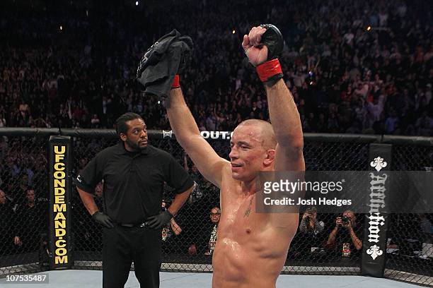 Georges St-Pierre celebrates after he won his fight by unanimous decision against Josh Koscheck during their Welterweight Title bout during UFC 124...