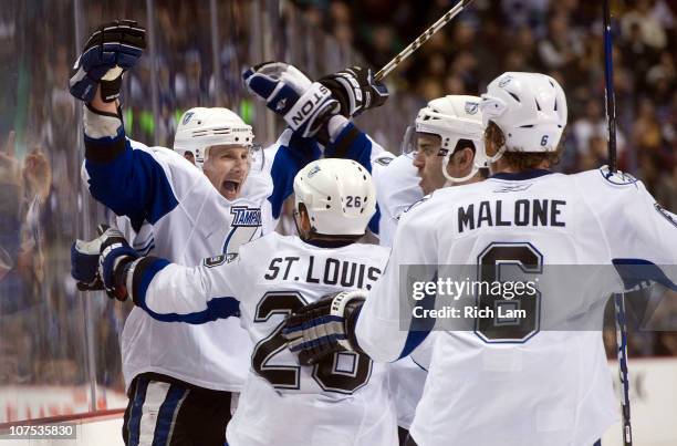 Steven Stamkos of the Tampa Bay Lightning celebrates with Martin St Louis, Ryan Malone and Teddy Purcell after scoring against the Vancouver Canucks...