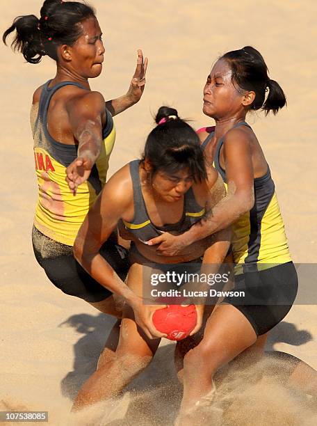 Nualjan Supaphan of Thailand is tackled in the Women's Beach Handball between Thailand and Indonesia at Al-Musannah Sports City during day five of...