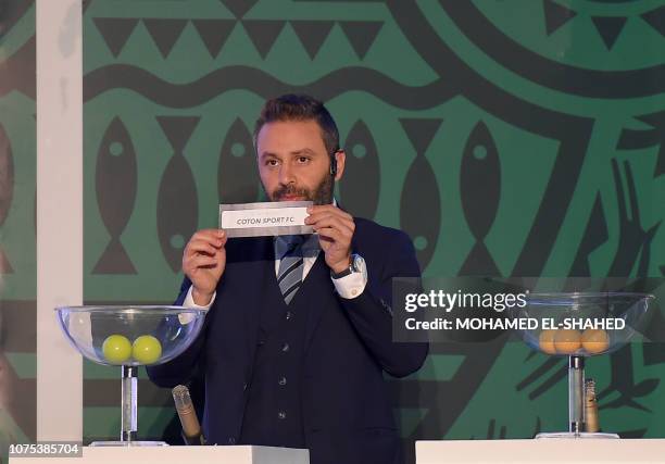 Former Egyptian player Hazem Mohammed Abdehamid Emam shows the results during the draw of the Confederation of African Football's Confederation cup...