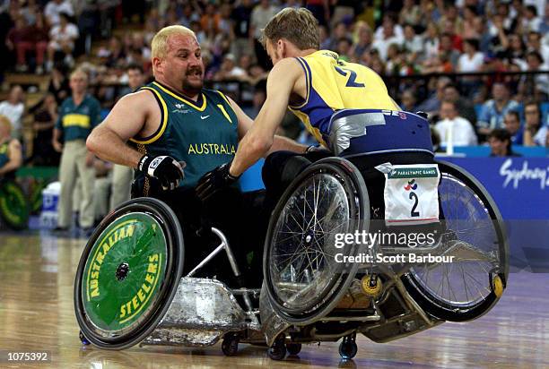 George Hucks of Australia and Pelle Kulle of Sweden collide during the Australia v Sweden Wheelchair Rugby match at the Sydney Paralympic Games held...