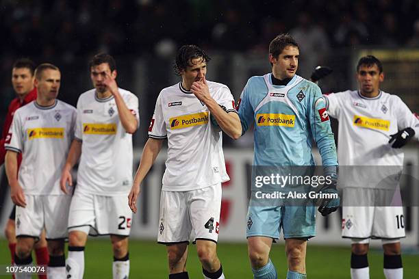 Roel Brouwers of M'Gladbach reacts as he is led off the pitch by goalkeeper Christofer Heimeroth during the Bundesliga match between SC Freiburg and...