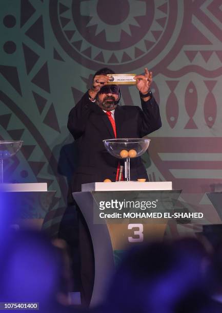 Magdi Abdelghani, former footballer and member of the Egyptian Football Federation, shows the results during the draw of the Confederation of African...
