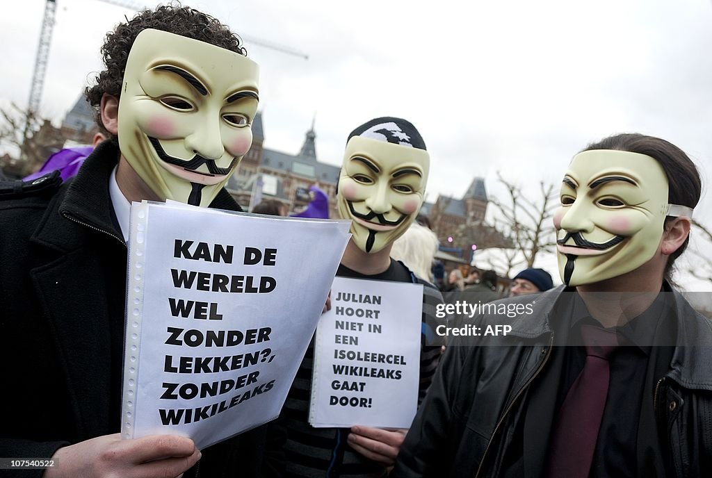 People wear masks with the face of Wikil
