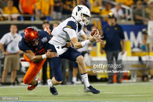 West Virginia Mountaineers quarterback Jack Allison is sacked by Syracuse Orange defensive lineman Tyrell Richards during the 2018 Camping World Bowl...