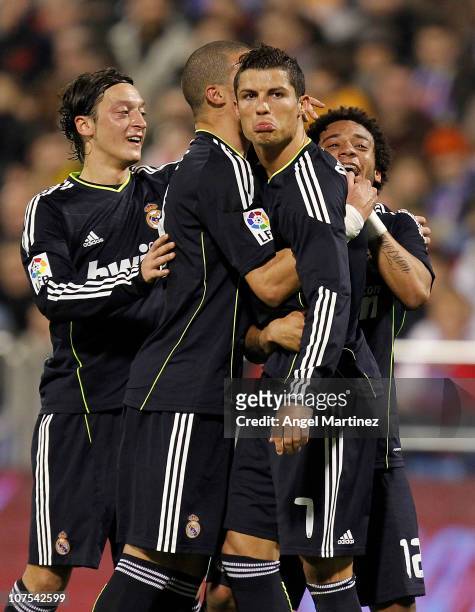 Cristiano Ronaldo of Real Madrid celebrates with his team mates Pepe, Mezut Ozil and Marcelo Vieira after scoring Real's second goal during the La...