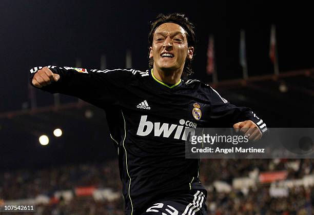 Mezut Ozil of Real Madrid celebrates after scoring Real's opening goal during the La Liga match between Real Zaragoza and Real Madrid at La Romareda...