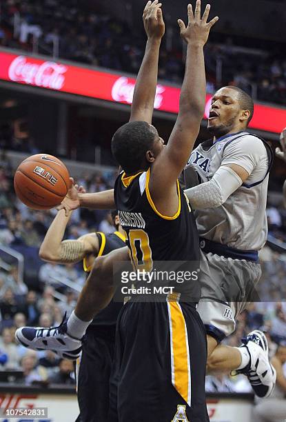 Georgetown guard Chris Wright, right, dishes the ball off around Appalachian State forward Andre Williamson during second-half action at the Verizon...