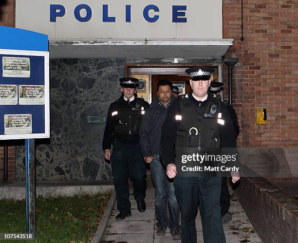 Shrien Dewani leaves Southmead Police station escorted by police officers after he reported there as part of his bail conditions on December 12, 2010...