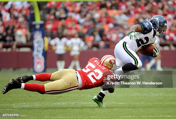 Patrick Willis of the San Francisco 49ers dives at the ankles of Marshawn Lynch of the Seattle Seahawks during an NFL football game at Candlestick...