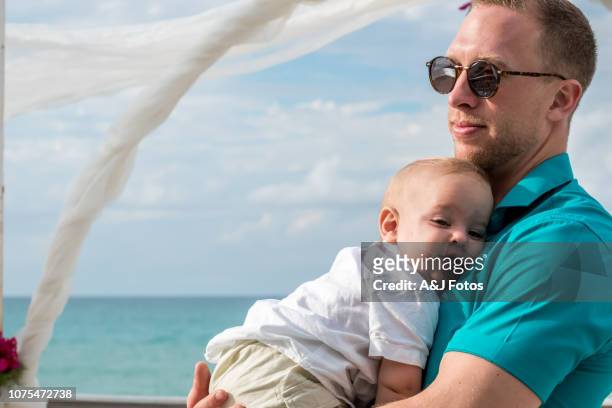a godfather and his young nephew in a wedding celebration - godfather stock pictures, royalty-free photos & images