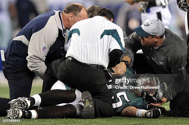 Linebacker Stewart Bradley of the Philadelphia Eagles is treated on the field after injuring his arm during the game against the Dallas Cowboys at...