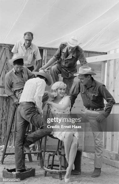 The cast and crew of John Huston's 'The Misfits' line up for a publicity shoot, USA, 1960. The group includes writer Arthur Miller, director John...