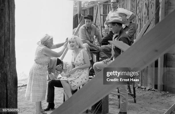 The cast and crew of John Huston's 'The Misfits' line up for a publicity shoot, USA, 1960. The group includes writer Arthur Miller, director John...