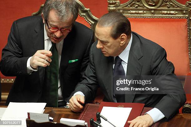 Italian Prime Minister Silvio Berlusconi speaks with Interior Minister Roberto Maroni during a debate at the Senate on December 13, 2010 in Rome,...