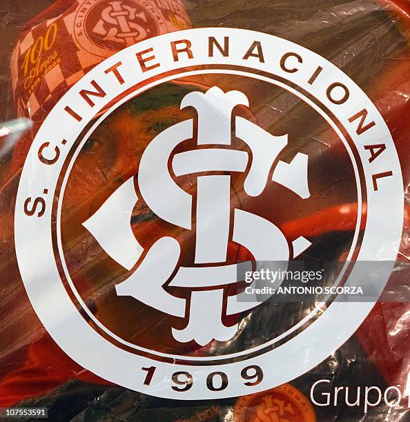 Fan of Brazilian Internacional football team appears behind a team's plastic flag before the Libertadores Cup final match against Mexico's Chivas on...