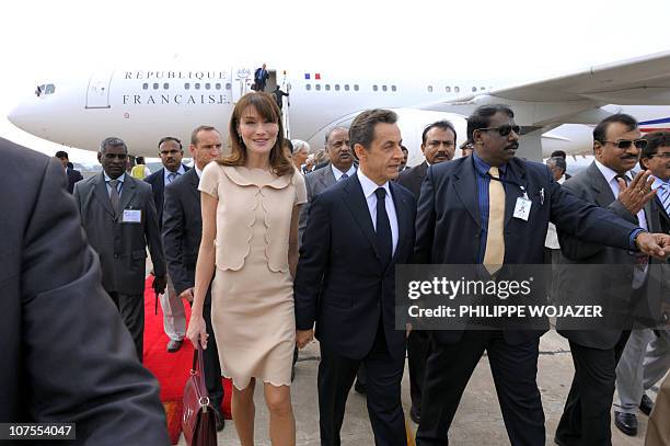 France's President Nicolas Sarkozy and First Lady Carla Bruni-Sarkozy arrive in Bangalore, on December 4, 2010. Accompanied by a high level...