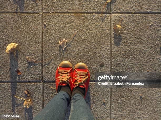 low section of woman standing on sidewalk - feet selfie woman stockfoto's en -beelden