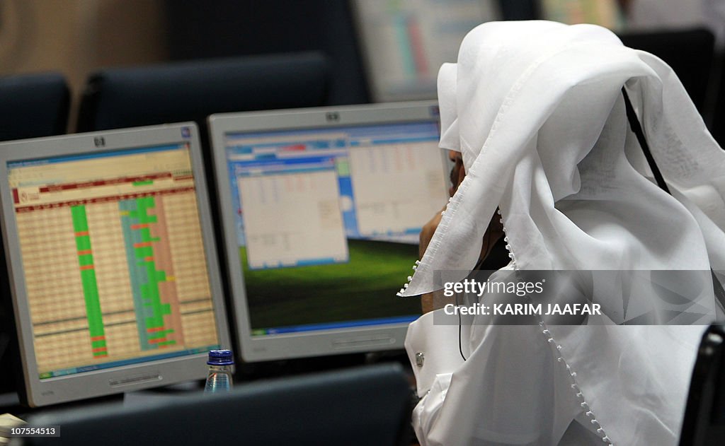 A Qatari trader follows the stock market