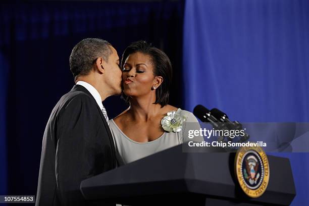 President Barack Obama kisses first lady Michelle Obama after delivering remarks before signing the Healthy, Hunger-Free Kids Act of 2010 at Harriet...