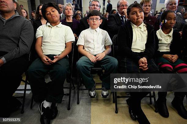 Students from Harriet Tubman Elementary School sit in the front row of the audience during the ceremony where U.S. President Barack Obama signed the...