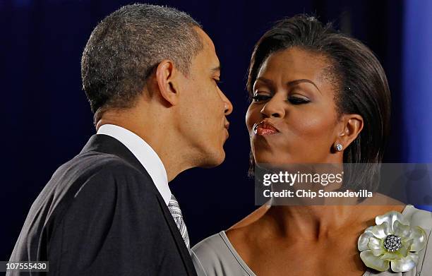 President Barack Obama kisses first lady Michelle Obama after delivering remarks and before signing the Healthy, Hunger-Free Kids Act of 2010 at...