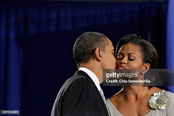 President Barack Obama kisses first lady Michelle Obama after delivering remarks before signing the Healthy, Hunger-Free Kids Act of 2010 at Harriet...